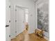 Bright hallway with beautiful wood floors and stylish accents, leading to a sunlit room at 613 Harrington Hls, Decatur, GA 30032