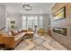Inviting living room featuring hardwood floors, modern furniture, a fireplace and bright natural light at 613 Harrington Hls, Decatur, GA 30032