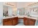Bathroom featuring dual vanities, ample lighting, and separate shower and tub at 6355 Marlow Dr, Cumming, GA 30041