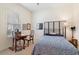 Cozy bedroom featuring a stylish bed, desk, and natural light from the window at 6355 Marlow Dr, Cumming, GA 30041