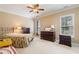 Cozy bedroom featuring neutral walls, carpet, and a comfortable bed with stylish decor at 6355 Marlow Dr, Cumming, GA 30041