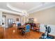 Formal dining room featuring hardwood floors, chandelier lighting, and classic furniture at 6355 Marlow Dr, Cumming, GA 30041