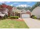 Beautiful brick home with well-manicured lawn, mature trees and attached two-car garage at 6355 Marlow Dr, Cumming, GA 30041