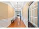 Elegant foyer with hardwood floors, wainscoting, chandelier, and view into the living area at 6355 Marlow Dr, Cumming, GA 30041