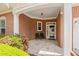 Charming brick front porch with seating area and well-maintained landscaping at 6355 Marlow Dr, Cumming, GA 30041