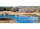 Picturesque view of the lush golf course pond and the stately country club beyond the green at 6355 Marlow Dr, Cumming, GA 30041