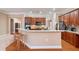 Open kitchen featuring wood cabinets, stainless steel appliances, and an island with bar stool seating at 6355 Marlow Dr, Cumming, GA 30041