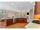 Bright kitchen featuring wood cabinets, stainless steel appliances, and a view to the living area at 6355 Marlow Dr, Cumming, GA 30041