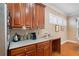Charming kitchen featuring wood cabinets, neutral countertops, and a delightful serving station at 6355 Marlow Dr, Cumming, GA 30041