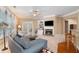 Cozy living room features a fireplace, built-in shelves, comfortable seating, and plenty of natural light at 6355 Marlow Dr, Cumming, GA 30041