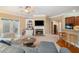 Spacious living room with a fireplace, built-in shelves, comfortable seating, and hardwood floors at 6355 Marlow Dr, Cumming, GA 30041