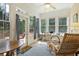 Inviting sunroom filled with natural light, showcasing a sitting area and outdoor views at 6355 Marlow Dr, Cumming, GA 30041