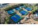 Aerial view shows multiple tennis courts and lush landscaping in the community at 6355 Marlow Dr, Cumming, GA 30041