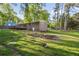 Expansive backyard featuring lush green grass, garden beds, mature trees, and potential for outdoor activities and gardening at 2079 Nancy Se Cir, Smyrna, GA 30080