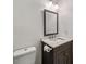 Bathroom featuring a marble-top vanity, decorative mirror, and modern lighting at 2079 Nancy Se Cir, Smyrna, GA 30080