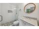 Modern bathroom with a glass shower, mosaic tile floor, and a marble vanity with round mirror at 2079 Nancy Se Cir, Smyrna, GA 30080