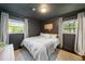 Cozy bedroom with neutral walls, natural light from two windows, and soft textures, offering a peaceful retreat at 2079 Nancy Se Cir, Smyrna, GA 30080