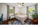 Cozy bedroom with hardwood floors, two windows with natural light, and a decorative rug at 2079 Nancy Se Cir, Smyrna, GA 30080