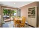 Charming dining area with a wooden table, chairs, built-in shelving, and sliding glass doors to the deck at 2079 Nancy Se Cir, Smyrna, GA 30080