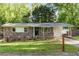 Charming brick home with a well-manicured lawn, mature trees, and welcoming front porch and tasteful landscaping at 2079 Nancy Se Cir, Smyrna, GA 30080
