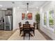 Elegant dining area with modern lighting, a wooden table, and a stylish area rug at 4065 Holland Grove Rd, Lawrenceville, GA 30044