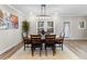 Cozy dining room featuring modern lighting, a wooden table, and a decorative plant at 4065 Holland Grove Rd, Lawrenceville, GA 30044