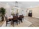 Inviting dining space with modern lighting, wood floors, and comfortable seating for six at 4065 Holland Grove Rd, Lawrenceville, GA 30044