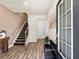 Bright entryway featuring hardwood floors, staircase, and modern accents for a welcoming entrance at 4065 Holland Grove Rd, Lawrenceville, GA 30044