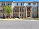 Exterior view of townhomes with a brick facade and covered front patios at 4065 Holland Grove Rd, Lawrenceville, GA 30044
