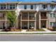 Charming townhome with brick facade, covered porch, and second-story balcony offers inviting curb appeal at 4065 Holland Grove Rd, Lawrenceville, GA 30044