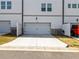 Two car garage with white garage door and a concrete driveway with sidewalk at 4065 Holland Grove Rd, Lawrenceville, GA 30044