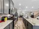 Charming kitchen boasts gray cabinets, stainless steel appliances, and a spacious granite island at 4065 Holland Grove Rd, Lawrenceville, GA 30044