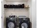 Laundry room features black front-load washer and dryer with storage shelf above at 4065 Holland Grove Rd, Lawrenceville, GA 30044