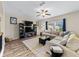 Bright living room features a plush sectional, ceiling fan, and modern decor at 4065 Holland Grove Rd, Lawrenceville, GA 30044