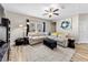 Spacious living room with comfortable sectional seating, ceiling fan, and stylish decor at 4065 Holland Grove Rd, Lawrenceville, GA 30044