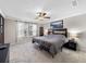Relaxing main bedroom with soft carpet, ceiling fan, and natural light from the windows at 4065 Holland Grove Rd, Lawrenceville, GA 30044