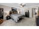 A cozy carpeted main bedroom featuring a ceiling fan and neutral walls at 4065 Holland Grove Rd, Lawrenceville, GA 30044