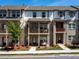 Modern townhome showcases a charming brick facade, open balconies, and a welcoming front patio at 4065 Holland Grove Rd, Lawrenceville, GA 30044