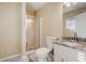 Bright bathroom featuring a shower, toilet and vanity with granite countertop and neutral walls at 715 Cowan Rd, Covington, GA 30016