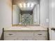 Bathroom showcasing a granite countertop, modern vanity, and a well-lit mirror at 715 Cowan Rd, Covington, GA 30016