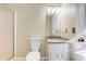 Simple bathroom features a toilet, vanity with granite countertop, decorative light fixture, and a walk-in shower at 715 Cowan Rd, Covington, GA 30016