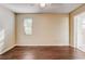 Well-lit bedroom with wood floors, a large window, and access to an ensuite bathroom at 715 Cowan Rd, Covington, GA 30016
