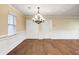 Dining room featuring hardwood floors, decorative wainscoting, and an elegant chandelier at 715 Cowan Rd, Covington, GA 30016