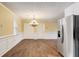 Charming dining room with wood floors, decorative ceiling, and classic chandelier at 715 Cowan Rd, Covington, GA 30016