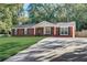 Beautiful single-story brick home with a spacious driveway and well-maintained lawn at 715 Cowan Rd, Covington, GA 30016