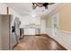 Open kitchen with white cabinetry, stainless steel appliances, and hardwood floors at 715 Cowan Rd, Covington, GA 30016