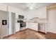 Modern kitchen featuring white cabinets, granite countertops, and stainless steel appliances at 715 Cowan Rd, Covington, GA 30016