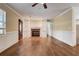 Inviting living room featuring hardwood floors, a brick fireplace, and custom built-in shelving at 715 Cowan Rd, Covington, GA 30016