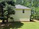 Rear exterior of the property with manicured lawn and a variety of surrounding trees at 99 Ashtonbrook Dr, Mcdonough, GA 30252