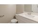 Bathroom featuring a white vanity, sink, and matching toilet at 99 Ashtonbrook Dr, Mcdonough, GA 30252
